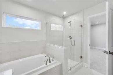 Bathroom with a stall shower and a garden tub