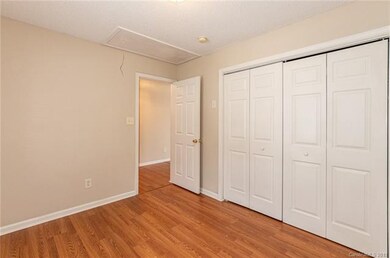 Secondary room with wood laminate flooring through