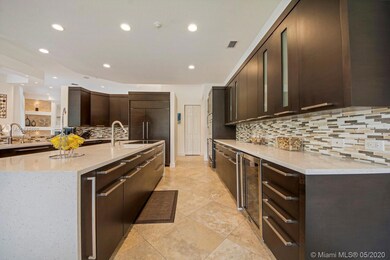 Newly renovated kitchen has wood cabinets, new appliances and quartz counter tops, two sinks and a beverage/wine cooler, with plenty of cabinet space and walk-in pantry. 