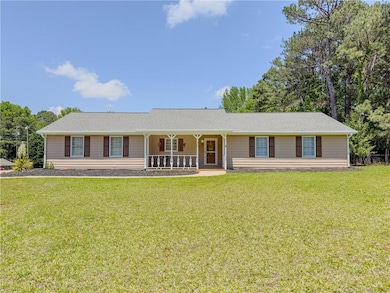 Ranch-style home with a porch and a front lawn