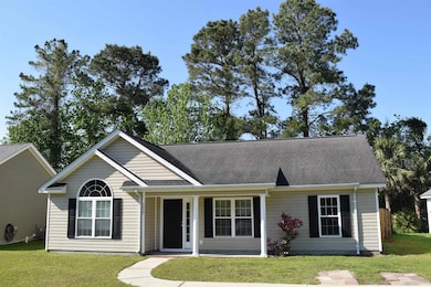 View of front of property with a shingled roof and a front lawn