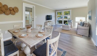 Dining space featuring crown molding and light hardwood / wood-style flooring