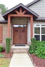 Double Wooden Front Doors with Cedar Beam Accents