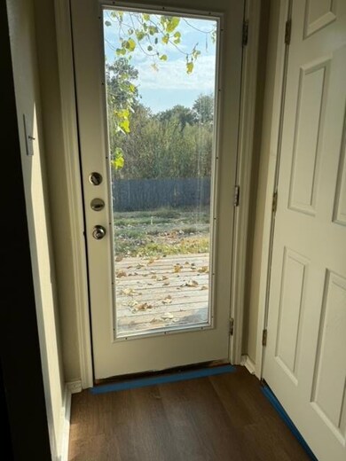 Doorway to outside featuring dark wood-style floo