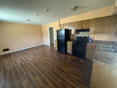 Kitchen featuring extractor fan, dark wood-style f