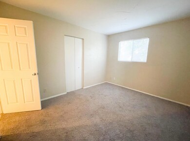 Unfurnished bedroom featuring carpet floors, base