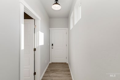 Hallway featuring baseboards and light wood-style flooring