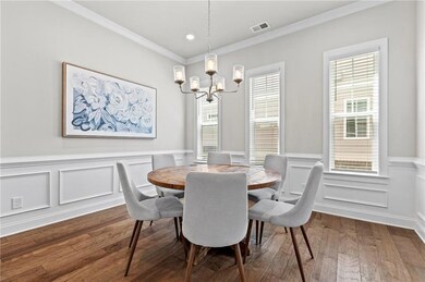 Dining room with a chandelier, dark wood-type floo