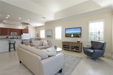 Tiled living room with a tray ceiling and a health