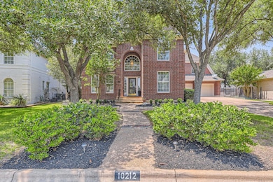 Traditional home with brick siding, driveway, fen