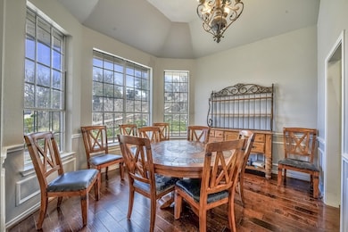 Dining room featuring dark wood-type flooring, a n