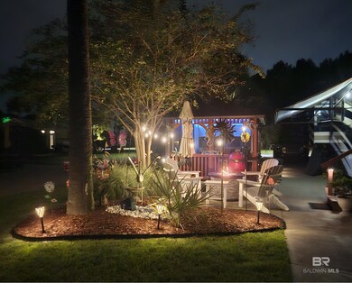 Patio at night featuring a patio and a gazebo
