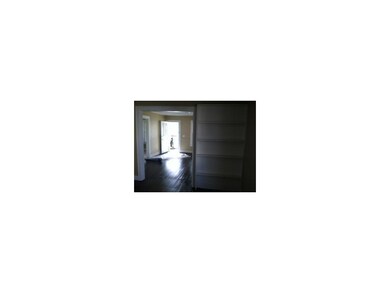 Dining room with built in bookcase looking into th