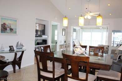 Dining room featuring light tile patterned floors, a ceiling fan, lofted ceiling, and recessed lighting