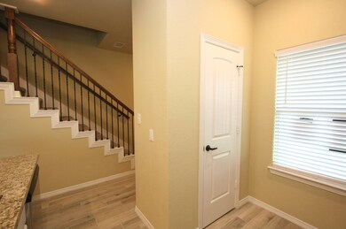Pantry in kitchen as well as a window to let in natural light. Raised panel doors with oil rubbed bronze door handles are on all doors throughout the home. Note wrought iron spindles on staircase.