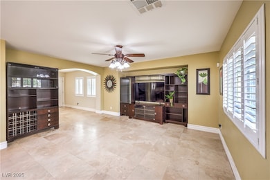 Unfurnished living room with ceiling fan, baseboar