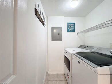 Clothes washing area with light tile patterned flo
