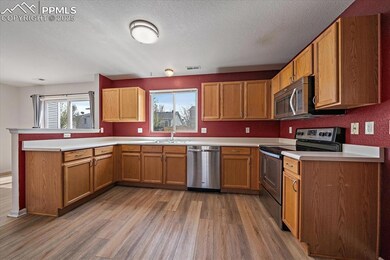 Kitchen featuring light wood-style flooring, a peninsula, visible vents, a sink, and stainless steel appliances
