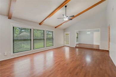 Unfurnished living room featuring beamed ceiling,