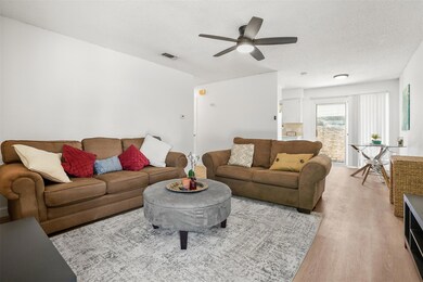 Living area with light wood-style flooring, ceili