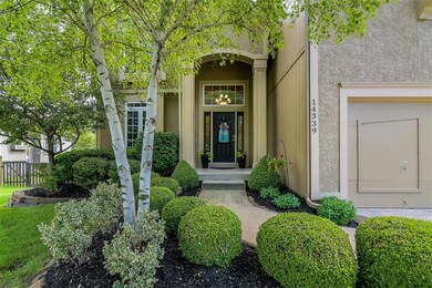 Boxwoods and a birch tree invite you to the front 