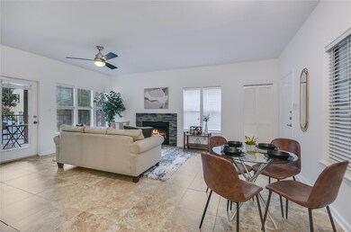 Dining area with ceiling fan and a fireplace