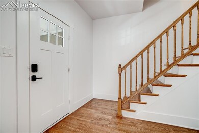 Entrance foyer featuring baseboards, stairway, and
