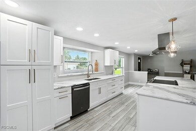 Kitchen with recessed lighting, white cabinetry, light stone counters, hanging light fixtures, and​​‌​​​​‌​​‌‌​​​‌​​‌‌​‌‌​​​‌‌‌​​​​‌​​​​​‌ dishwasher