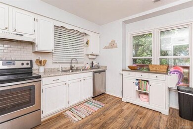 Newer backsplash, lots of windows, stainless steel