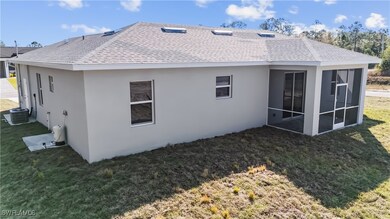 Rear view of property featuring a yard, a sunroom,