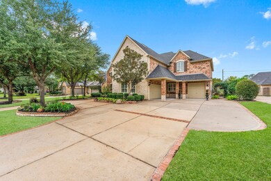 Exquisite LANDSCAPING has Mature Oak & Magnolia Trees, Shrubs and Lush Flowering Plants, Walls Crafted Of Stone, Brick & Boulder Give Beds Definition & Accentuate the Elevation. 2 GARAGES (4-car capacity) - Overhang adds character & CONVENIENCE IN RAIN!!! FINISHED & Tons of Shelving; SIDE-BY-SIDE: OVERSIZED, incl workbench & plumbed for Util Sink. The TANDEM has 9’ Door and 10’ Ceiling for boat/tall vehicles. With Striking Inlaid Brick Detail; the Lg Circle Drive, Dbl-Wide & Parking Pad has PARKING FOR 10!!