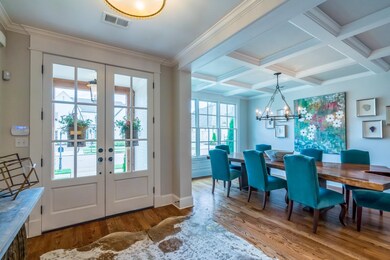 Finished wood beams enhance this expansive dining 