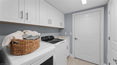 Laundry area featuring light wood-style floors, ca