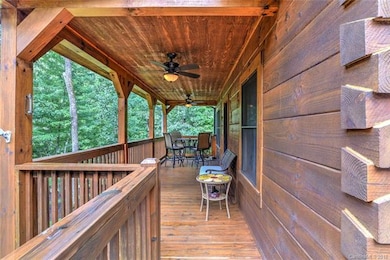 Large front porch overlooking the pond and firepit