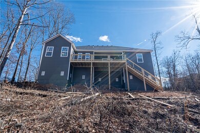 Deck with reasonably level backyard surrounded by nature and POA space