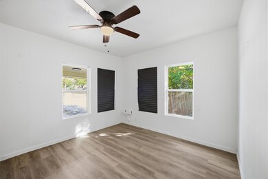 Unfurnished room with light wood finished floors and ceiling fan