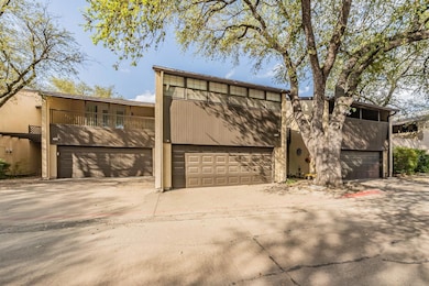 View of front of home featuring a garage, a balcon