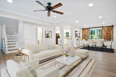 Living room with ornamental molding, light wood-ty