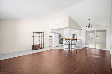 Unfurnished living room with high vaulted ceiling,