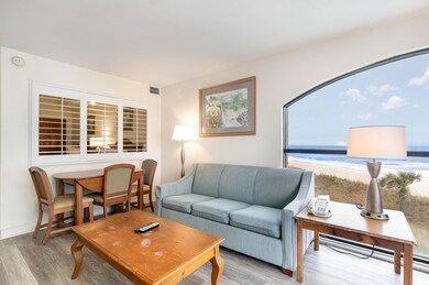 Living room featuring a water view and light hardw