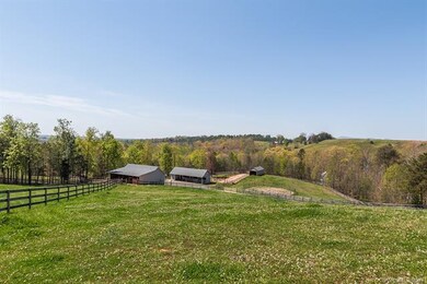 Farm buildings include a three stall barn with a t