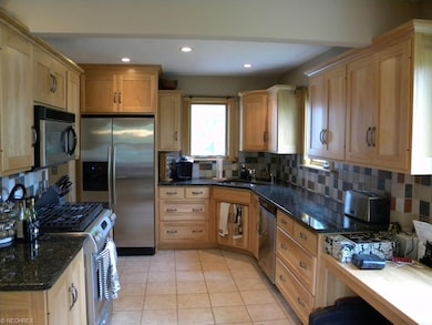 Gourmet kitchen with granite counter tops and cera