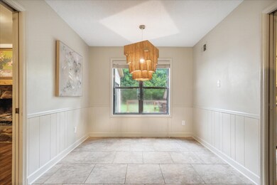 Unfurnished dining area with an inviting chandelie