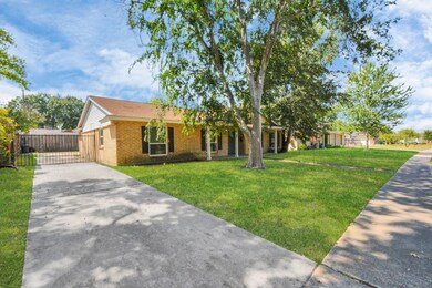 The long driveway wraps around to the back of the home where the two car garage sits.
