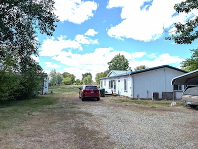 View of home's exterior featuring driveway and a metal roof