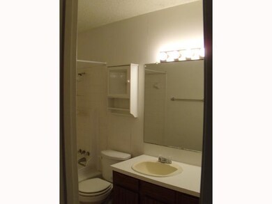Bathroom featuring toilet, vanity, and shower / b