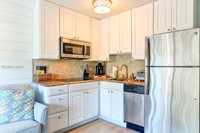 Kitchen with sink, light hardwood / wood-style flo