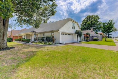 View of front of property with asphalt driveway, brick siding, and roof with shingles