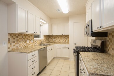 Deep stainless steel sink and window overlooking b
