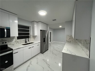 Kitchen featuring light stone countertops, stainle